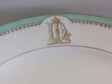 a close up of a plate with a monogram on it