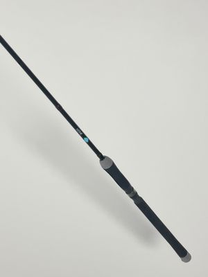 a close up of a fishing rod on a white surface