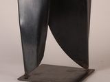 an image of a black sculpture on a metal stand