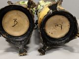 two vases that have been decorated with flowers on them