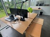 a man sitting at a desk with a computer on it