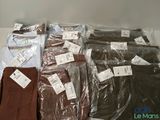 several pairs of men ' s pants are wrapped in plastic bags