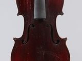 an old violin with a bow hanging from it ' s back
