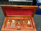 a small wooden box with a miniature house inside of it