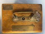 a close up of a wooden box with a metal handle