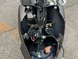 a motor scooter that has a bunch of wires attached to it