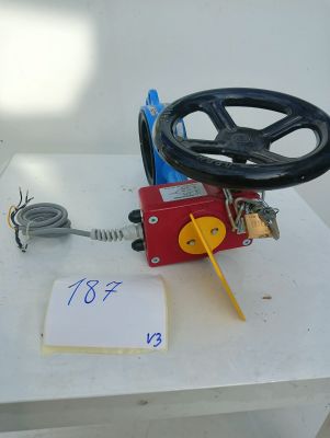 a red valve on a white table with a sign on it