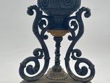 a blue vase sitting on top of a wooden stand