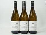 three bottles of wine sitting on top of a white table