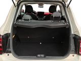 the back of a white car with its trunk open and the back seats down