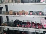a lot of makeup products on the shelves in the store
