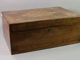 an old wooden box sitting on top of a white table
