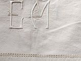 a white towel that has a monogram on it