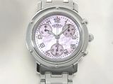 a close up of a watch on a white surface