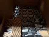 many pieces of metal in a box with a brown ribbon