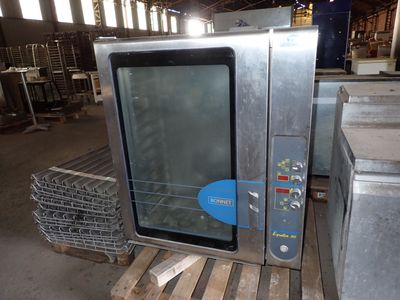 a small oven sitting on a pallet in a warehouse