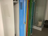 brightly colored lockers line the walls of a bathroom with a shower