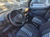 dashboard of a small car with black seats and a white van in the background