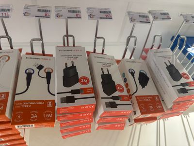 several boxes of electronic devices are stacked on a rack in a store