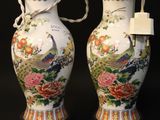two vases that have been decorated with flowers and peacocks