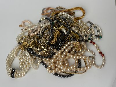 a pile of pearls and other jewelry on a table