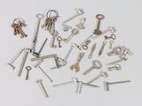 a lot of keys that are laying on a white surface