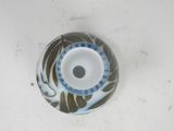 a small blue and white vase on a white table