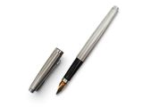 a close up of a pen and a ballpoint pen on a white surface