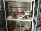 a shelf with dishes and glasses on it in a room