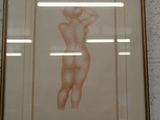a picture of a nude woman in a frame on the wall