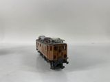 two toy trains that are sitting on a white surface