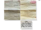 two pieces of paper and a piece of paper with writing on it