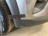 a measuring tape on the side of a car ' s tire