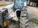 a tractor that is parked on the side of the road