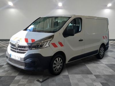 the white van is parked on a checkered floor in the garage