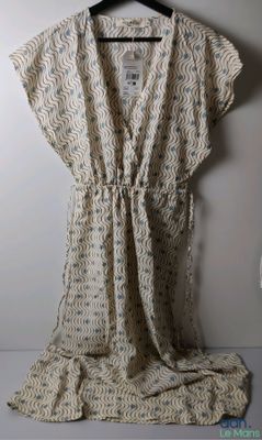 an image of a dress hanging on a hanger on a wall