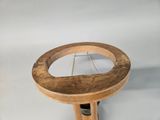 a small wooden table with a mirror on top of it