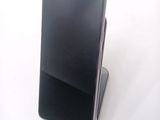 a cell phone that is sitting on top of a stand