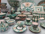many different types of pottery on display on the table