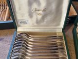 a lot of spoons in a case on the table
