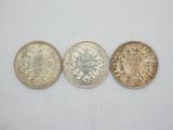 three different types of coins on a white surface
