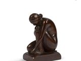 sculpture of a woman kneeling on a wooden base