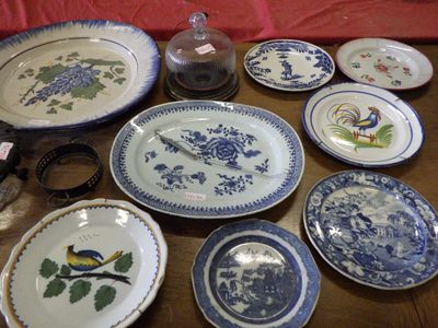 many plates and bowls on the table with a red table cloth