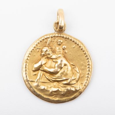 a close up of a gold coin with a woman on it