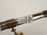 a close up of a telescope with a key on a chain