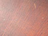 a close up of a wooden table with a brown top