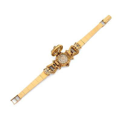 a close up of a wrist watch on a white surface