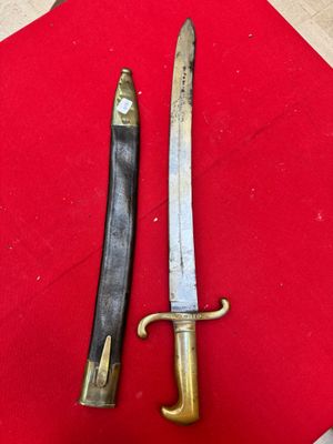 two knives are sitting on a red cloth on a table