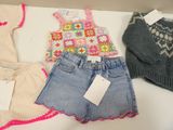 three pairs of shorts and a sweater on a table