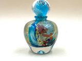 une petite bouteille en verre ornée d'un motif coloré